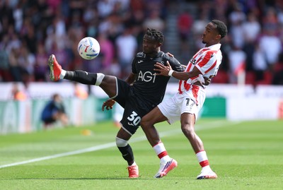 150826 - Stoke City v Swansea City, EFL Sky Bet Championship - Joseph Opoku of Swansea City and Eric Bocat of Stoke City compete for the ball