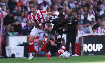 150826 - Stoke City v Swansea City, EFL Sky Bet Championship - Joseph Opoku of Swansea City holds off Svante Ingelsson of Stoke City