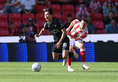 150826 - Stoke City v Swansea City, EFL Sky Bet Championship - Ji-Sung Eom of Swansea City is brought down by Robert Bozenik of Stoke City
