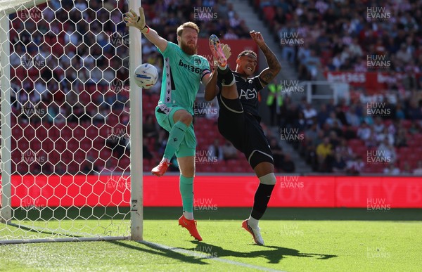150826 - Stoke City v Swansea City, EFL Sky Bet Championship - Adam Idah of Swansea City challenges Stoke City goalkeeper Viktor Johansson for the ball