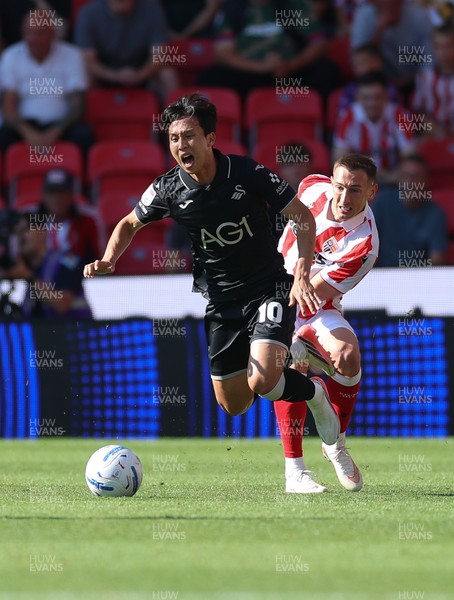 150826 - Stoke City v Swansea City, EFL Sky Bet Championship - Ji-Sung Eom of Swansea City is brought down by Robert Bozenik of Stoke City