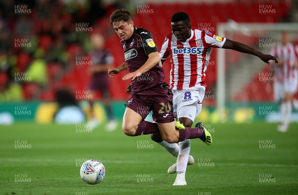 180918 - Stoke City v Swansea City - SkyBet Championship - Daniel James of Swansea City is tackled by Oghenekaro Etebo of Stoke City