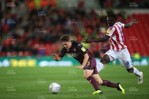 180918 - Stoke City v Swansea City - SkyBet Championship - Daniel James of Swansea City is tackled by Oghenekaro Etebo of Stoke City