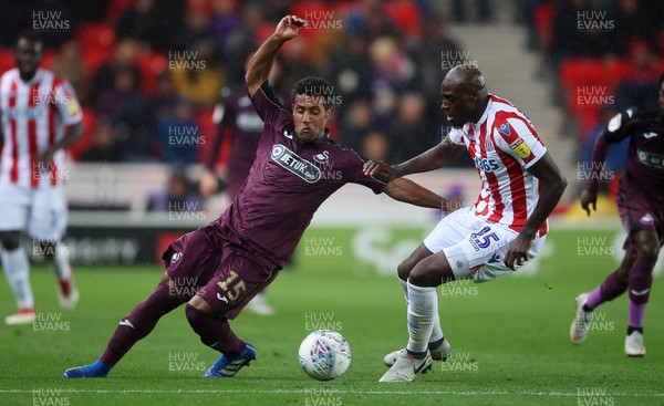 180918 - Stoke City v Swansea City - SkyBet Championship - Wayne Routledge of Swansea City is tackled by Bruno Martins Indi of Stoke City