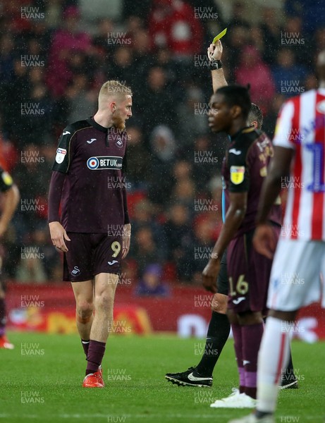 180918 - Stoke City v Swansea City - SkyBet Championship - Oliver McBurnie of Swansea City is given a yellow card by referee Paul Tierney