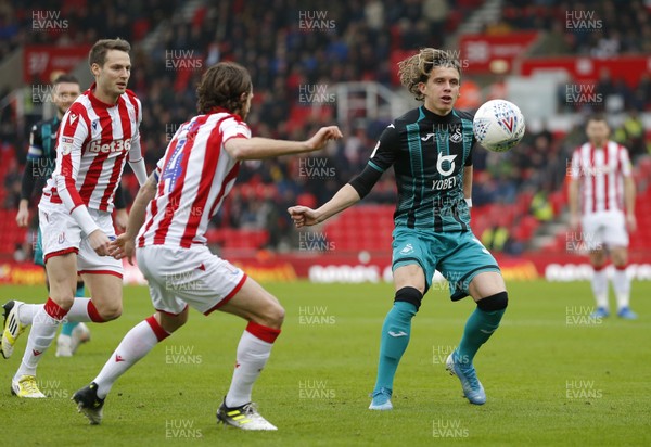 250120 - Stoke City v Swansea City - Sky Bet Championship - Conor Gallagher  of Swansea traps the ball with Joe Allen of Stoke City looking on