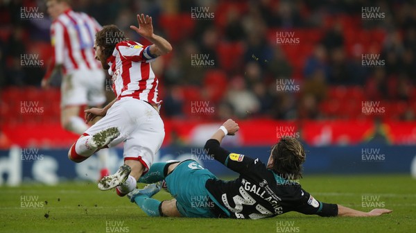 250120 - Stoke City v Swansea City - Sky Bet Championship - Conor Gallagher  of Swansea takes the ball away from Joe Allen of Stoke City   