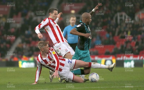 250120 - Stoke City v Swansea City - Sky Bet Championship - Andre Ayew of Swansea is downed by Sam Clucas of Stoke City   