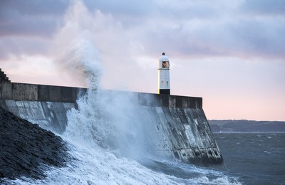 210918 - Picture shows the waves crash on the lighthouse in Porthcawl, South Wales, as Storm Branagh starts to hit the UK