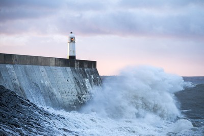 210918 - Picture shows the waves crash on the lighthouse in Porthcawl, South Wales, as Storm Branagh starts to hit the UK