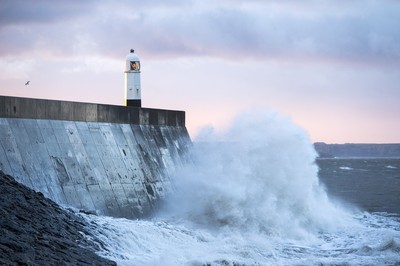 210918 - Picture shows the waves crash on the lighthouse in Porthcawl, South Wales, as Storm Branagh starts to hit the UK