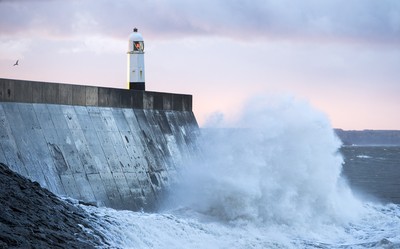 210918 - Picture shows the waves crash on the lighthouse in Porthcawl, South Wales, as Storm Branagh starts to hit the UK