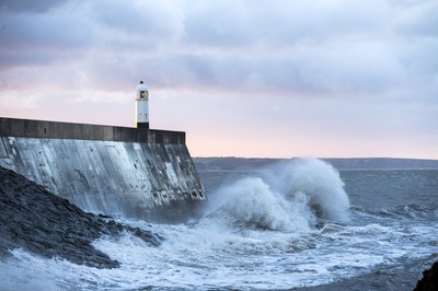 210918 - Picture shows the waves crash on the lighthouse in Porthcawl, South Wales, as Storm Branagh starts to hit the UK