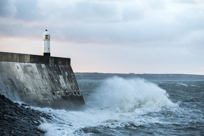 210918 - Picture shows the waves crash on the lighthouse in Porthcawl, South Wales, as Storm Branagh starts to hit the UK