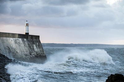 210918 - Picture shows the waves crash on the lighthouse in Porthcawl, South Wales, as Storm Branagh starts to hit the UK