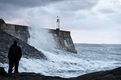 210918 - Picture shows the waves crash on the lighthouse in Porthcawl, South Wales, as Storm Branagh starts to hit the UK