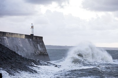 210918 - Picture shows the waves crash on the lighthouse in Porthcawl, South Wales, as Storm Branagh starts to hit the UK