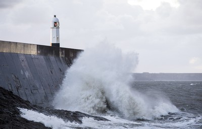 210918 - Picture shows the waves crash on the lighthouse in Porthcawl, South Wales, as Storm Branagh starts to hit the UK