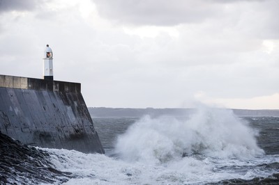 210918 - Picture shows the waves crash on the lighthouse in Porthcawl, South Wales, as Storm Branagh starts to hit the UK