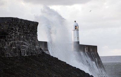 210918 - Picture shows the waves crash on the lighthouse in Porthcawl, South Wales, as Storm Branagh starts to hit the UK