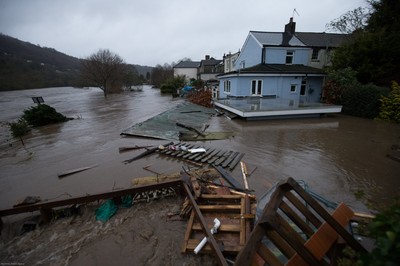 160220 - Flooding hits homes in Taffs Well north of Cardiff in south Wales as the River Taff, on the left, bursts it's banks from the effects of storm Dennis