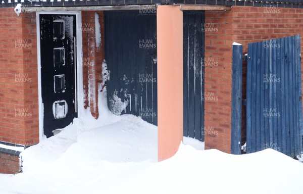 020318 - Weather - A doorway and garage full of snow at a house in Penarth near Cardiff, South Wales after being hit by Storm Emma
