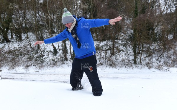 020318 - Weather - Alex Bywater stands in deep snow in Penarth near Cardiff, South Wales after being hit by Storm Emma