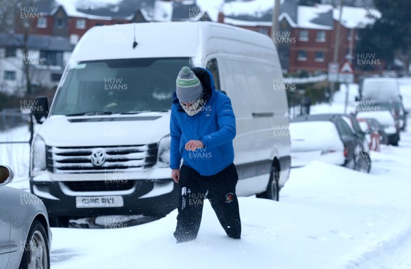 020318 - Weather - Alex Bywater walks through deep snow in Penarth near Cardiff, South Wales after being hit by Storm Emma