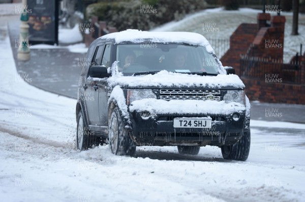 020318 - Weather - A 4x4 tries to make its way through the snow in Penarth near Cardiff, South Wales after being hit by Storm Emma