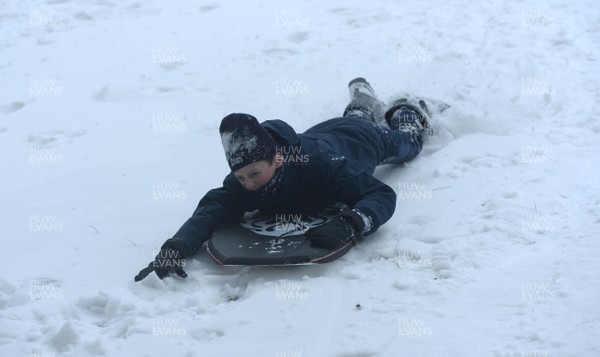 020318 - Weather - A child sledges in Penarth near Cardiff, South Wales after being hit by Storm Emma