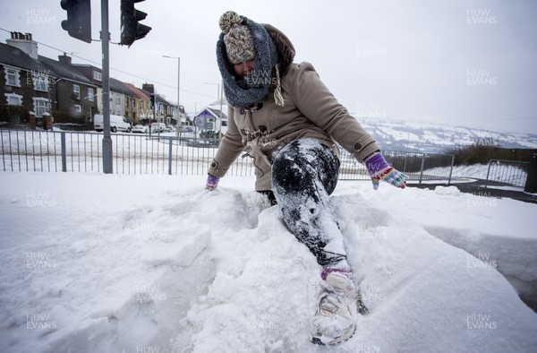 020318 - Picture shows a women struggling through the heavy snowfall in Pontypridd, South Wales after Storm Emma hit the area overnight