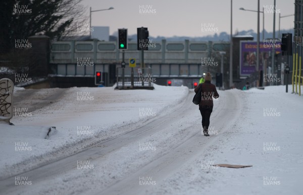 020318 - Storm Emma, Cardiff - A pedestrian makes her way down one of the usually busy rush hour main roads in Cardiff city centre this morning after storm Emma hits south Wales and the South West, forcing many to stay at home