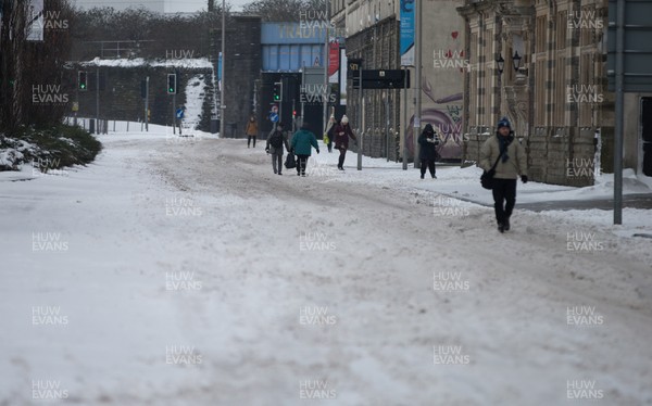 020318 - Storm Emma, Cardiff - Pedestrians make their way down one of the usually busy rush hour main roads in Cardiff city centre this morning after storm Emma hits south Wales and the South West, forcing many to stay at home