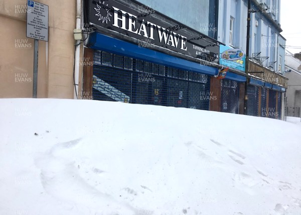 030318 - Weather - Shop fronts blocked by snow drifts in Brynmawr, South Wales after being hit by Storm Emma