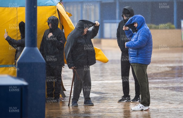 180222 - Picture shows people struggling in the high winds at Barry Island, Wales during Storm Eunice today, as the region has been issued with a rare red weather warming