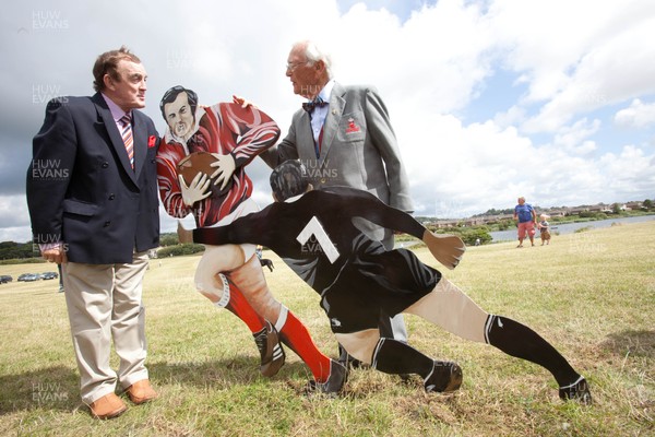 030813 - Unveiling of Stradey Park rugby posts and statue at  Sandy Park, Llanelli - Llanelli RFC legends Phil Bennett and Peter Rees with the statue depicting him playing against the All Blacks at the newly located rugby posts from Llanelli's old Stradey Park at Sandy Park on the Millennium Coastal Path