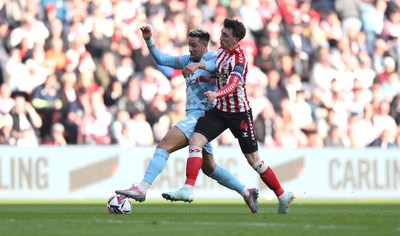 080325 - Sunderland v Cardiff City - Sky Bet Championship - Dan Neil of Sunderland and Callum Robinson of Cardiff City