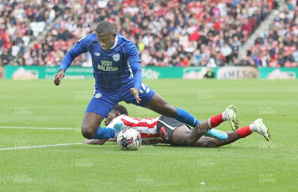 240923 - Sunderland v Cardiff City - Sky Bet Championship - Jamilu Collins of Cardiff is felled by Abdoullah Ba of Sunderland AFC