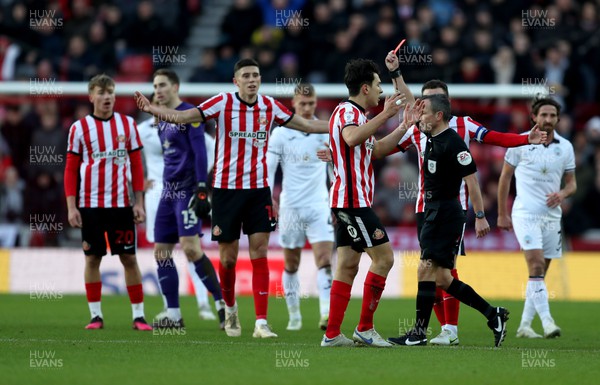 140123 - Sunderland v Swansea City - Sky Bet Championship - Players come together after a challenge by Luke O'Nien of Sunderland who is then sent off by referee Keith Stroud