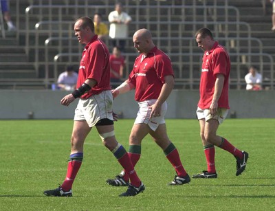 030601 - Suntory v Wales - Chris Stephens, Ben Evans and Geraint Lewis walk off the field after defeat in Tokyo