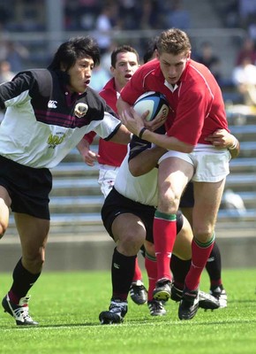 030601 - Suntory v Wales - Jamie Robinson is tackled by Kazunaka Motoyoshi