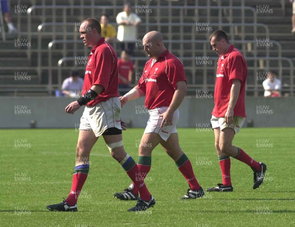 030601 - Suntory v Wales - Chris Stephens, Ben Evans and Geraint Lewis walk off the field after defeat in Tokyo