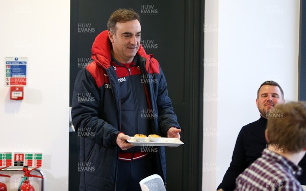 080218 - Swansea City manager Carlos Carvalhal hands out cakes to the media before his press conference