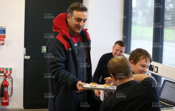 080218 - Swansea City manager Carlos Carvalhal hands out cakes to the media before his press conference