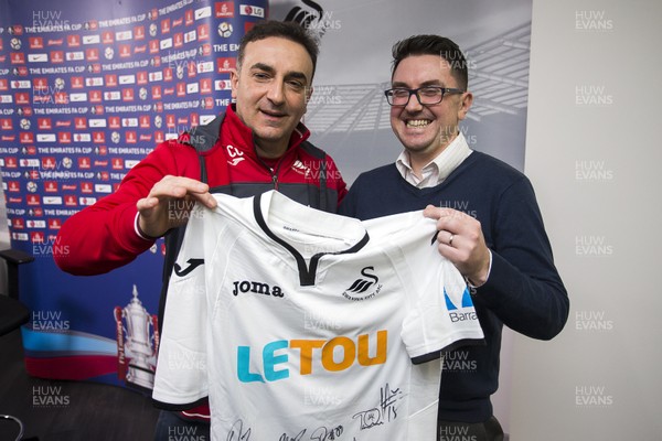 150218 - Swansea City Press Conference - Swansea City manager Carlos Carvalhal presents a signed shirt to WalesOnline chief football writer Chris Wathan