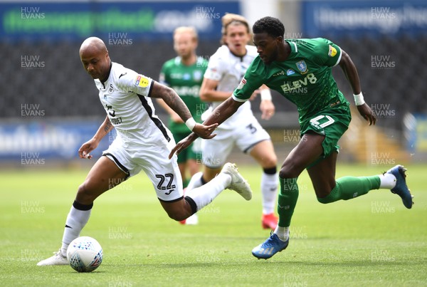 050720 - Swansea City v Sheffield Wednesday - SkyBet Championship - Andre Ayew of Swansea City is tackled by Dominic Iorfa of Sheffield Wednesday