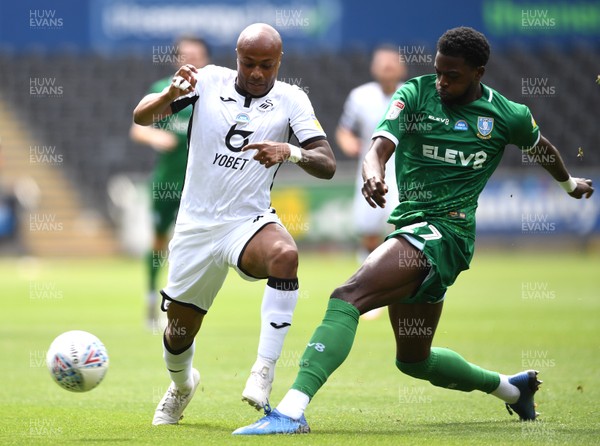 050720 - Swansea City v Sheffield Wednesday - SkyBet Championship - Andre Ayew of Swansea City is tackled by Dominic Iorfa of Sheffield Wednesday