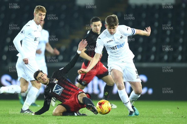 240117 - Swansea City Under 21s v Coventry - Checkatrade Trophy - Keston Davies of Swansea City gets past Ruben Lameiras of Coventry