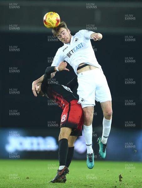 240117 - Swansea City Under 21s v Coventry - Checkatrade Trophy - Ryan Blair of Swansea City gets above Ruben Lameiras of Coventry