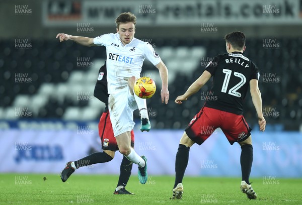 240117 - Swansea City Under 21s v Coventry - Checkatrade Trophy - Ryan Blair of Swansea City is tackled by Callum Reilly of Coventry